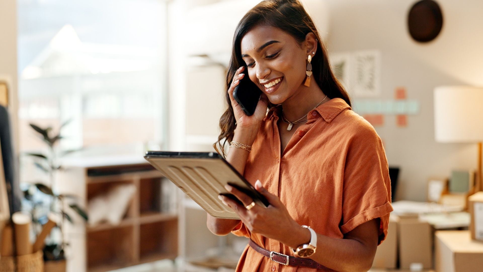 Woman using tablet and phone together