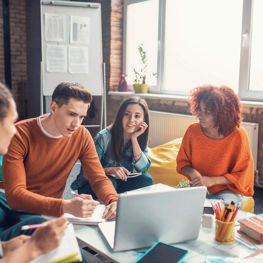A group of people sitting together and having a meeting.