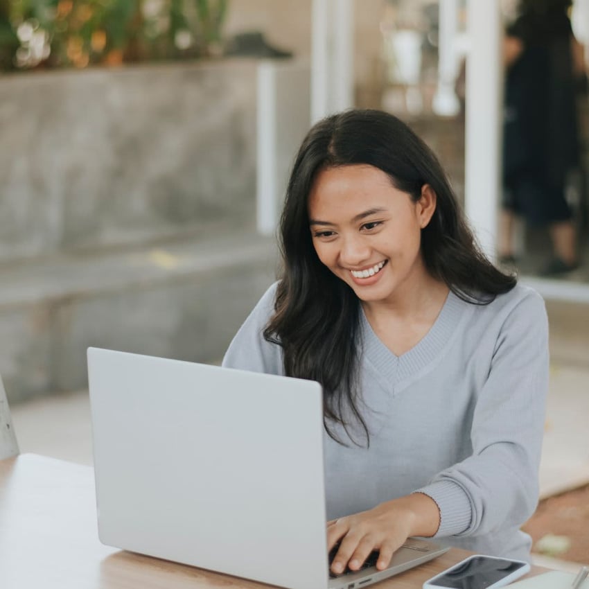 Women smiling at laptop