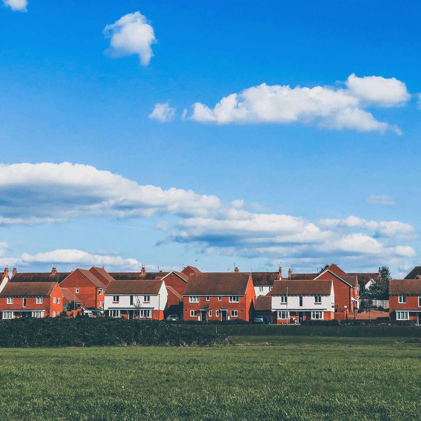 A group of houses under a bright, sunny sky