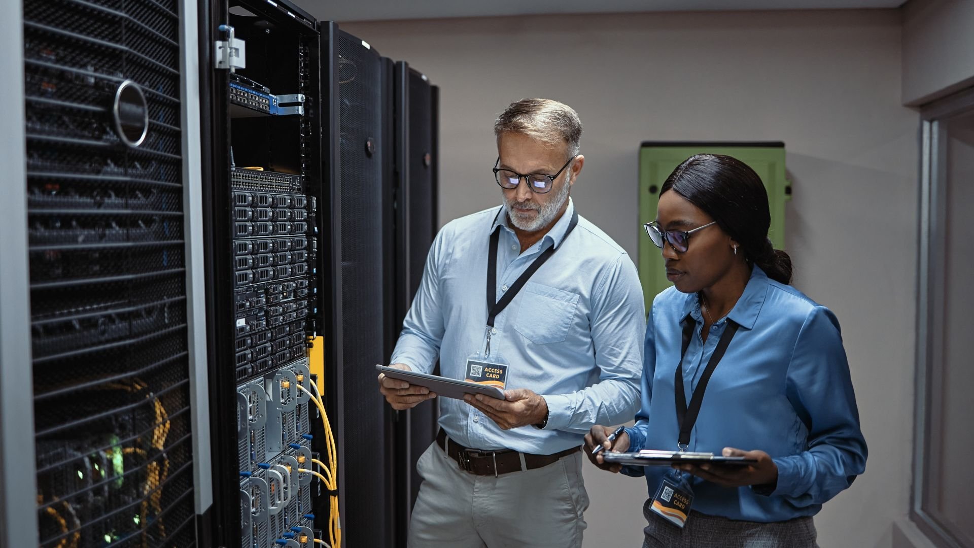 Two coworkers working together in a datacenter