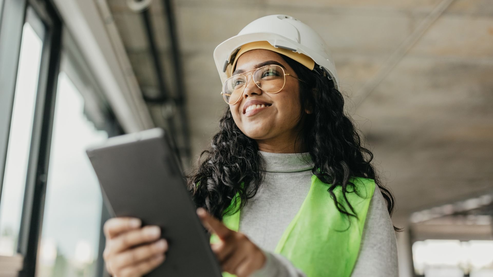 Woman working on tablet in construction environment