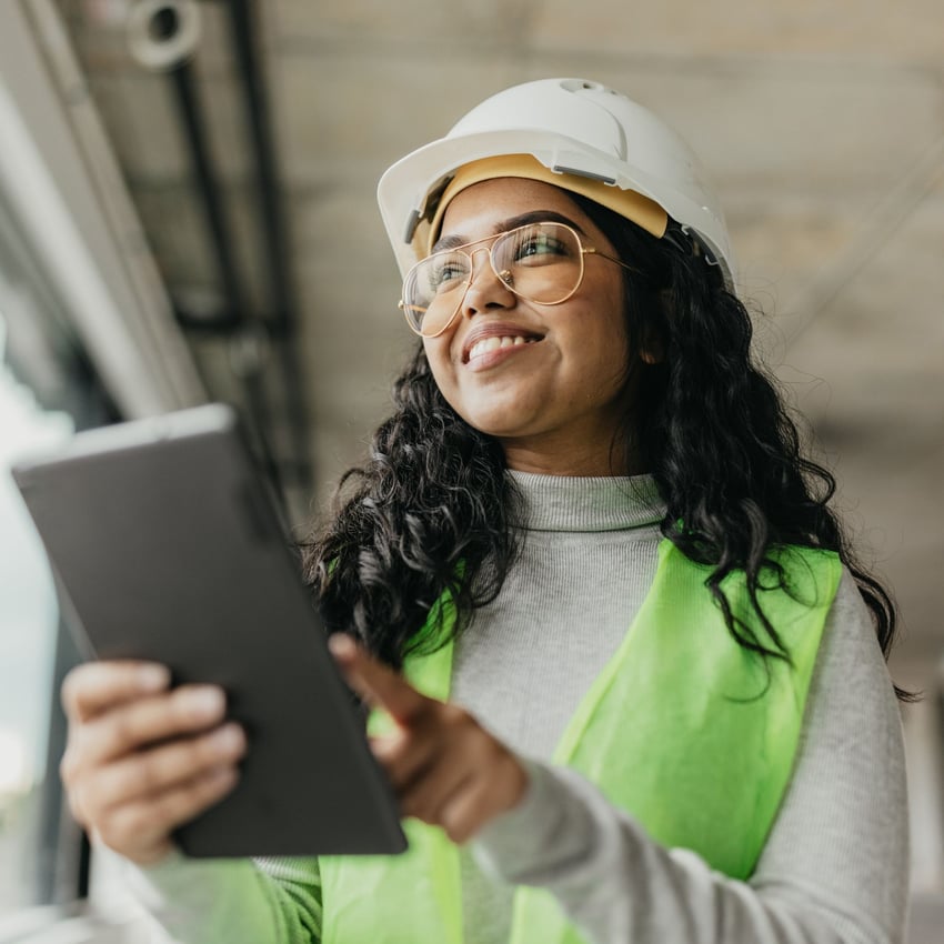 Woman working on an tablet in a construction environment