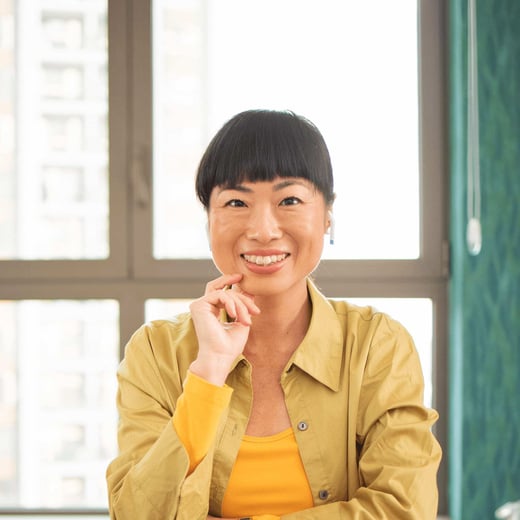 Woman in yellow shirt looking for best university degrees for older adults UK