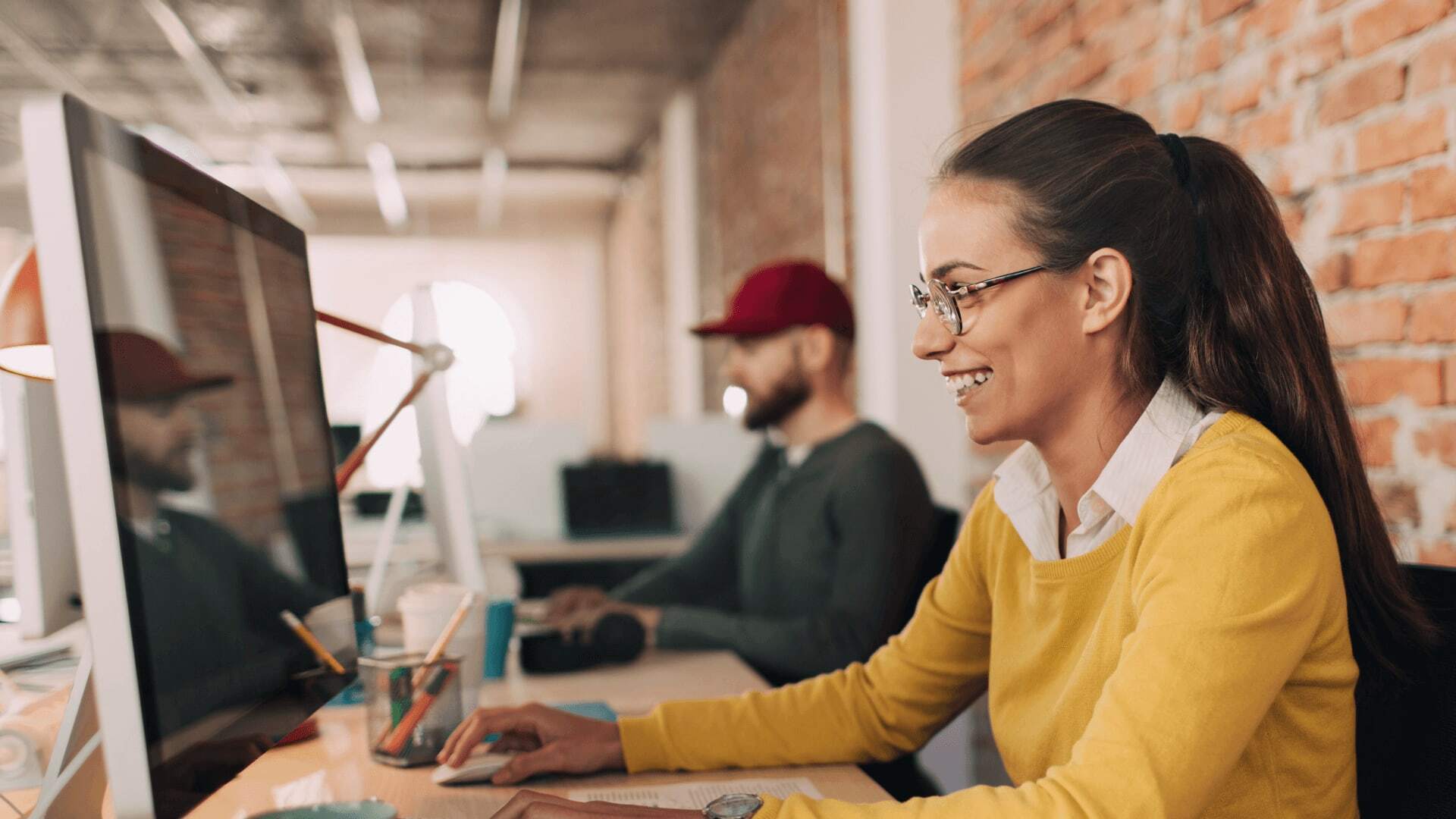 Woman working on assignments with other college students from her office.