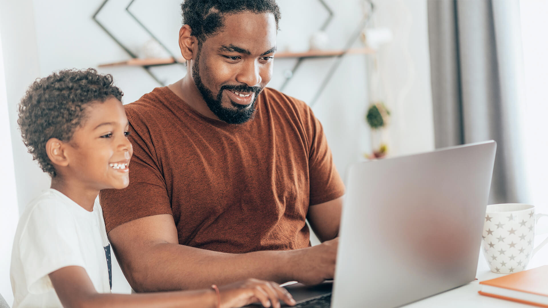 Distance learning student studying with family at home.