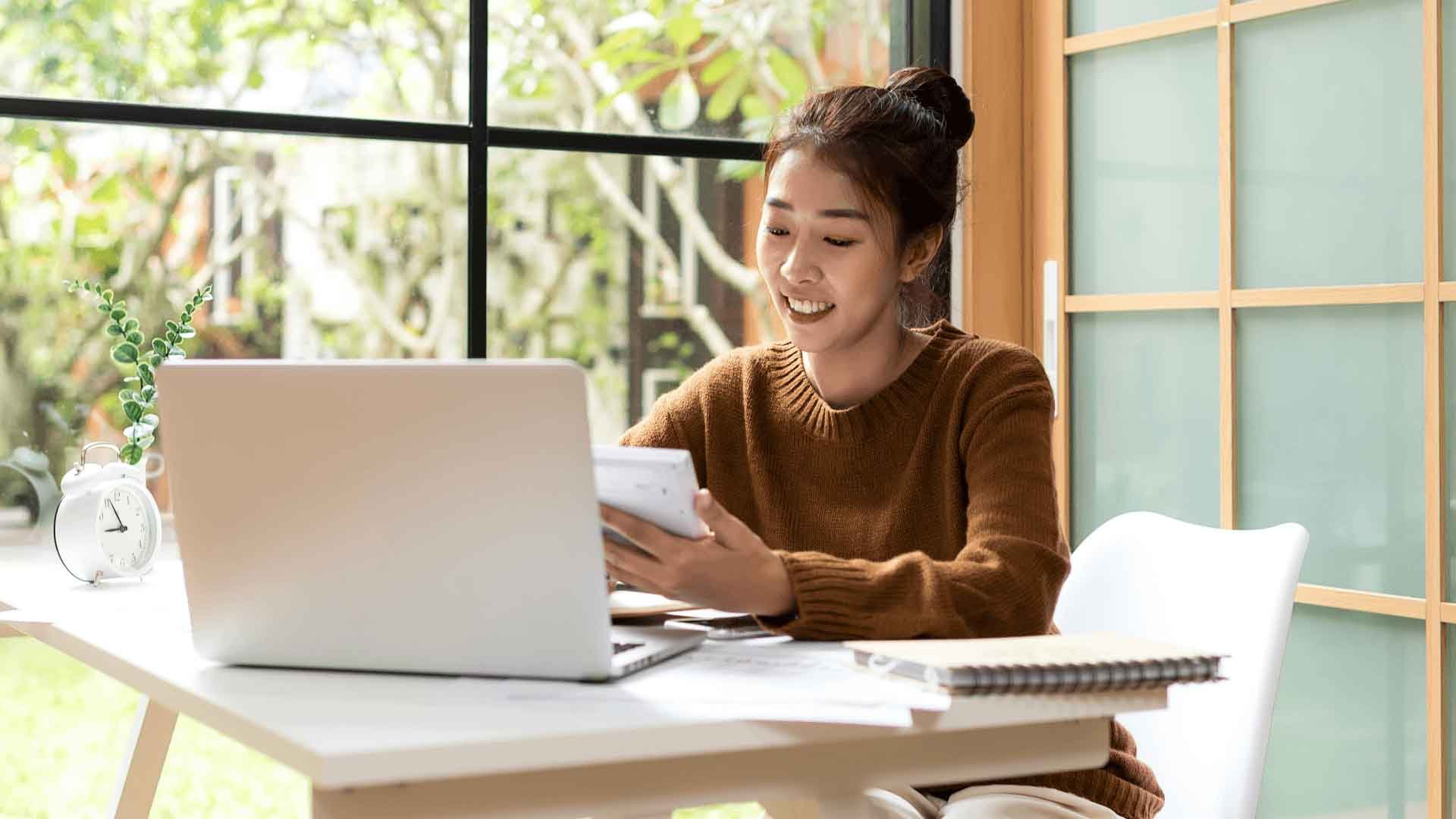 Woman in brown jumper using exam tips to overcome exam stress
