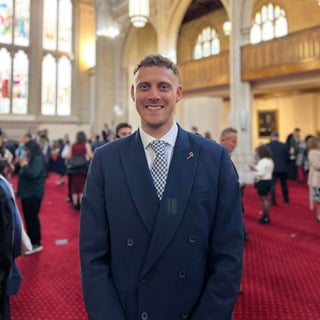 Headshot of Adam Belfield at Graduation