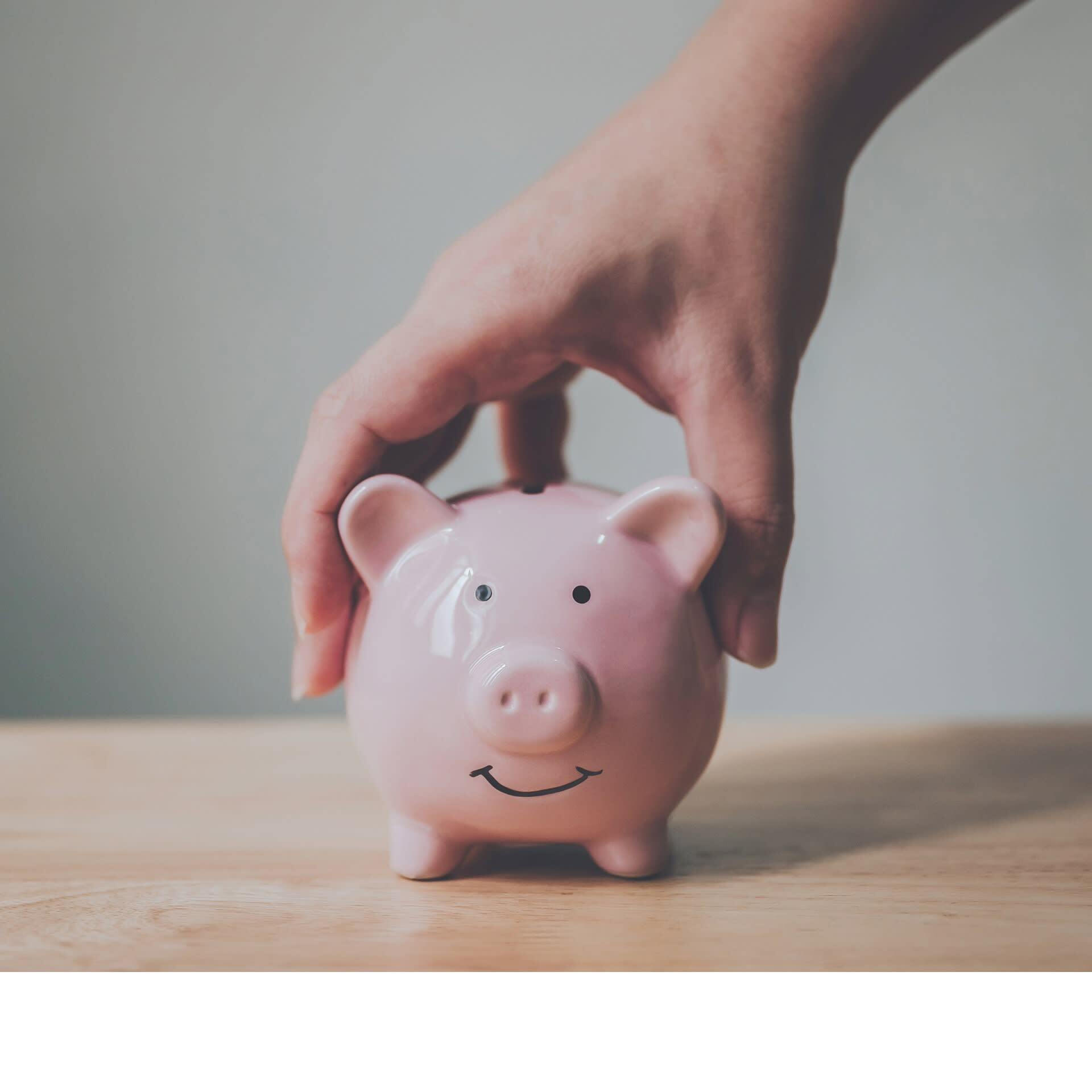 Piggy bank being lifted up