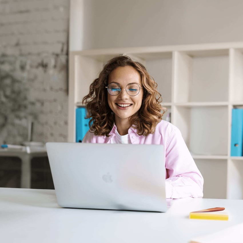 A young woman wearing glasses researching good things foundation