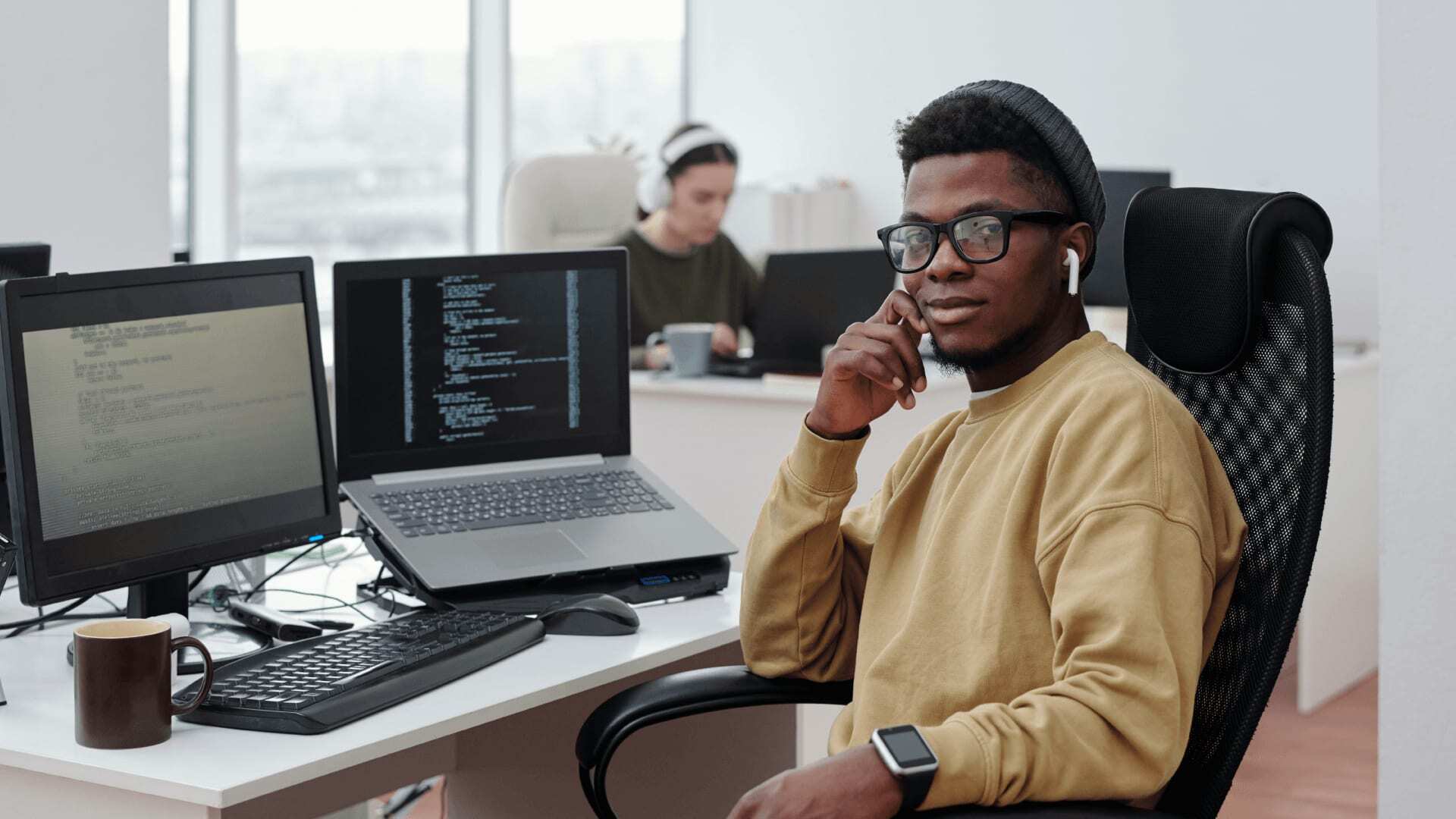 Male AI engineer using programming skills to create AI models from a laptop.