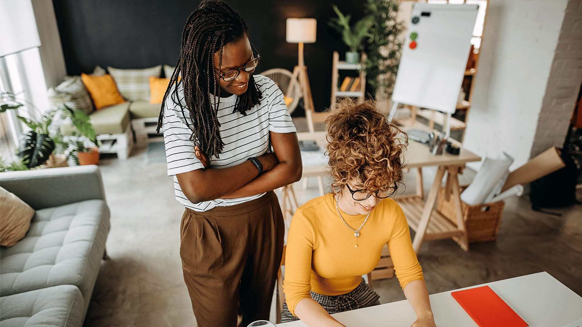 AI engineer and machine learning engineer work together in a home office.