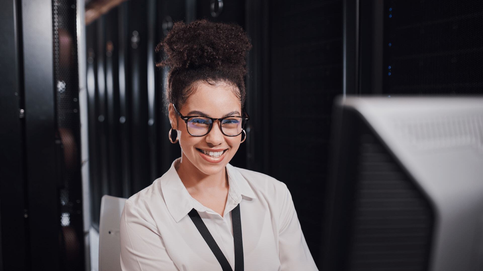Woman in shirt and glasses researching undergraduate degrees in AI and computer science.