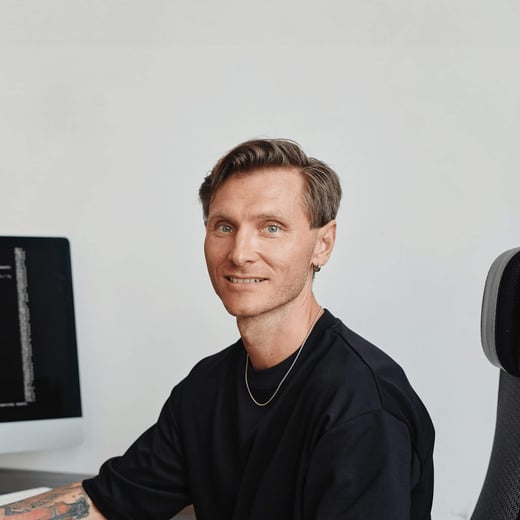 Man at desk in black t-shirt learning how to become a software developer
