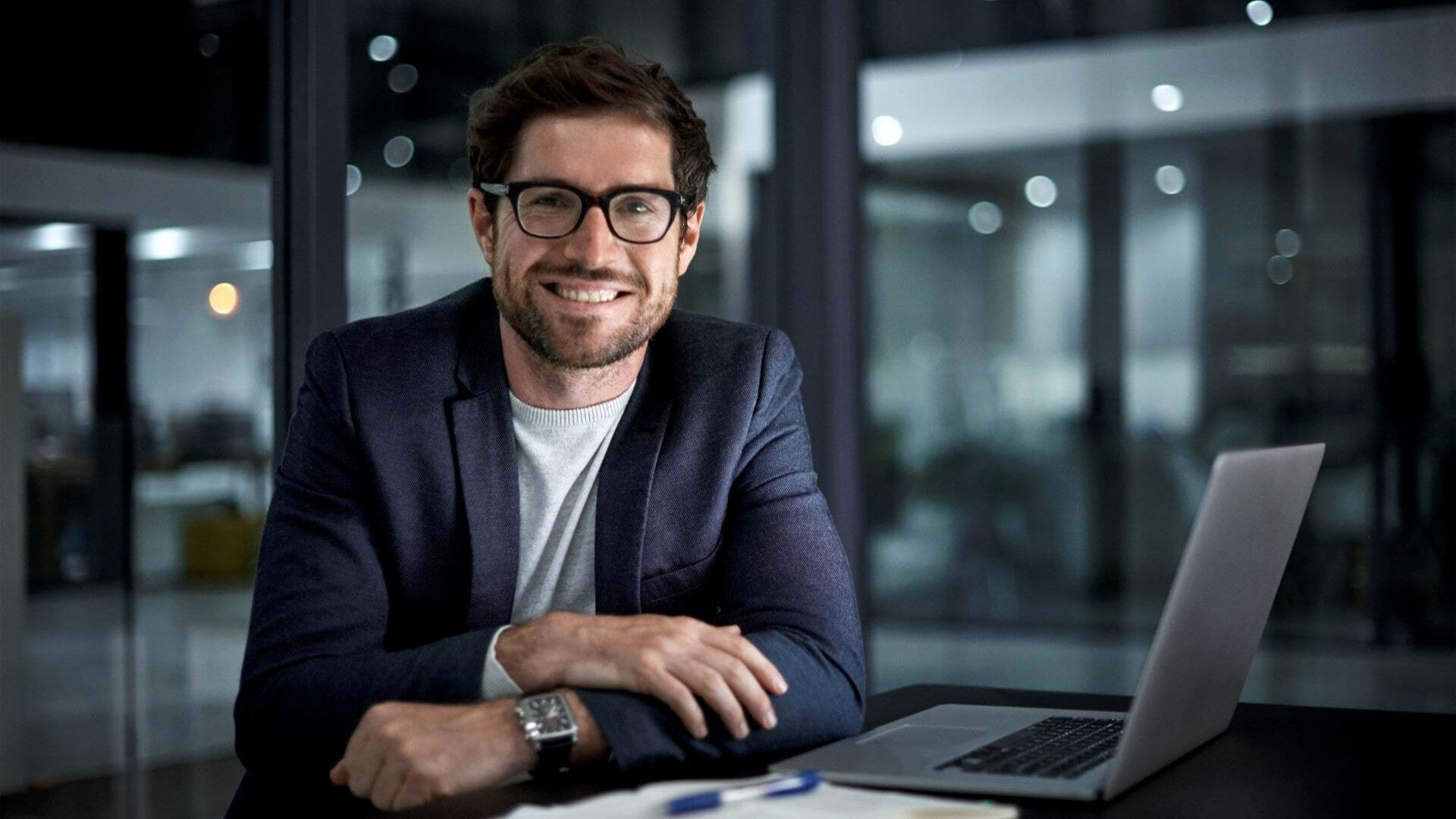 A man sat in a modern office, preparing an analytics report