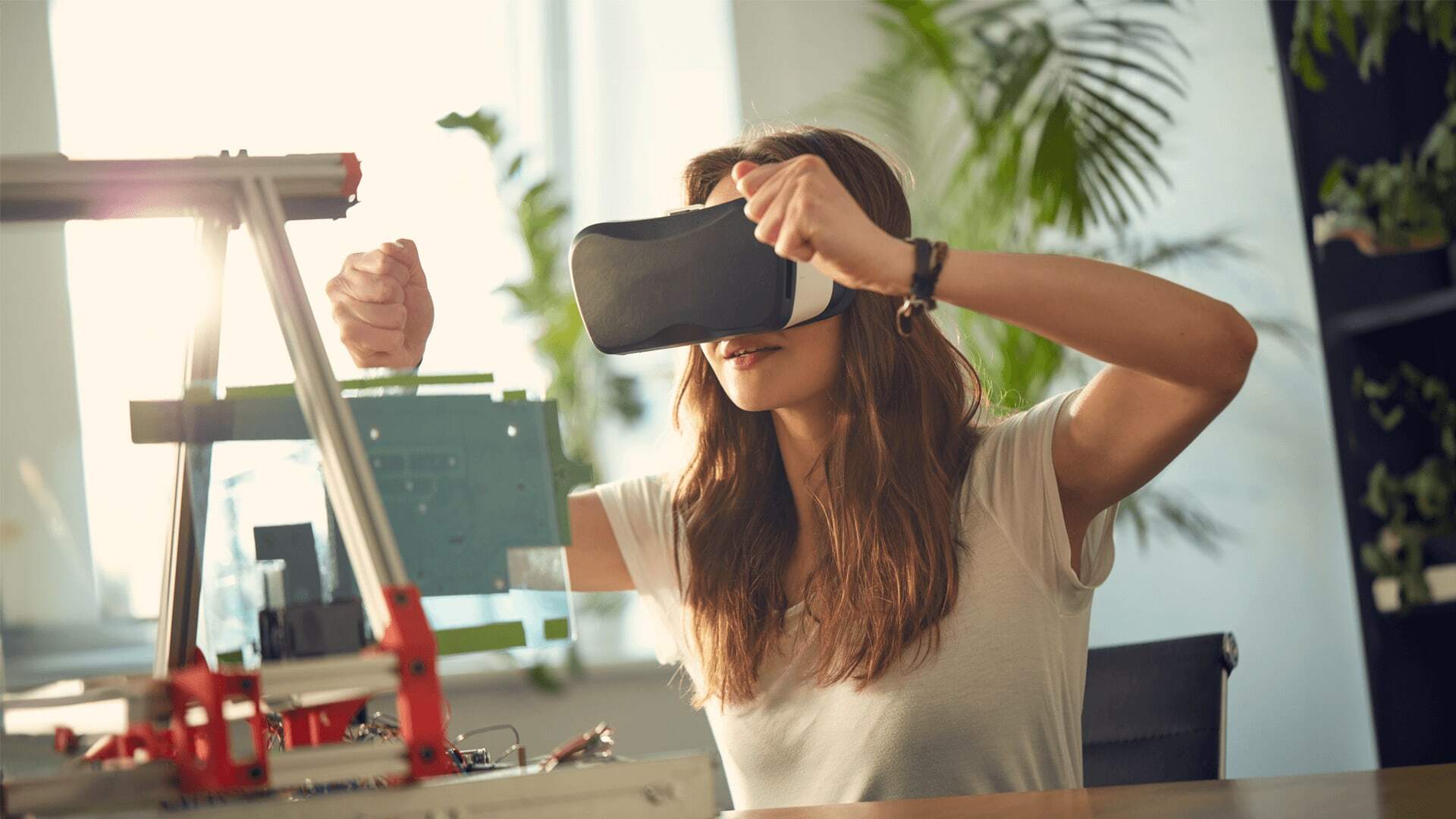 Developer using a virtual reality headset to work on a project involving general-purpose language and server-side languages, with a focus on Android apps and agile software development.