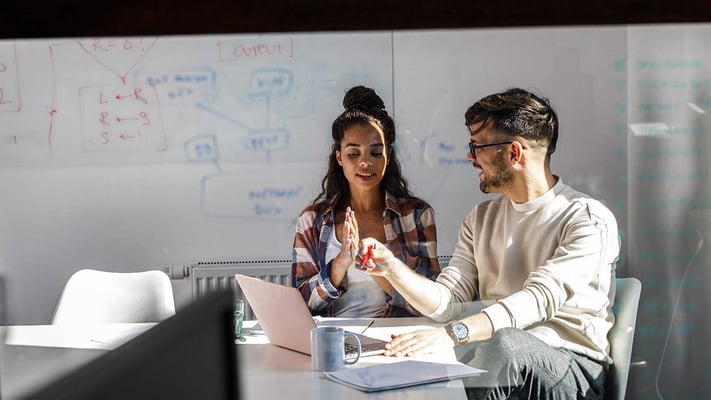 Two data management team members reviewing required data and ensuring up-to-date information for accurate analysis.