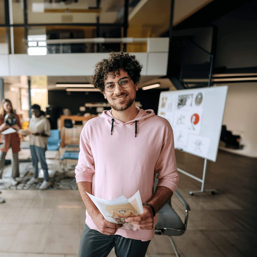 Professional data manager stand in busy office in pink hoodie