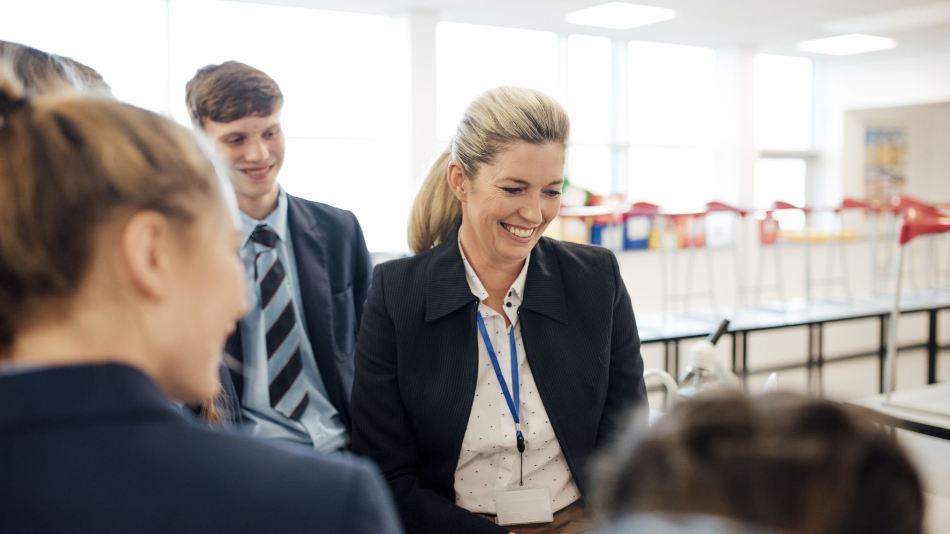 Teacher laughing with students