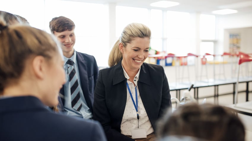 Teacher laughing with students