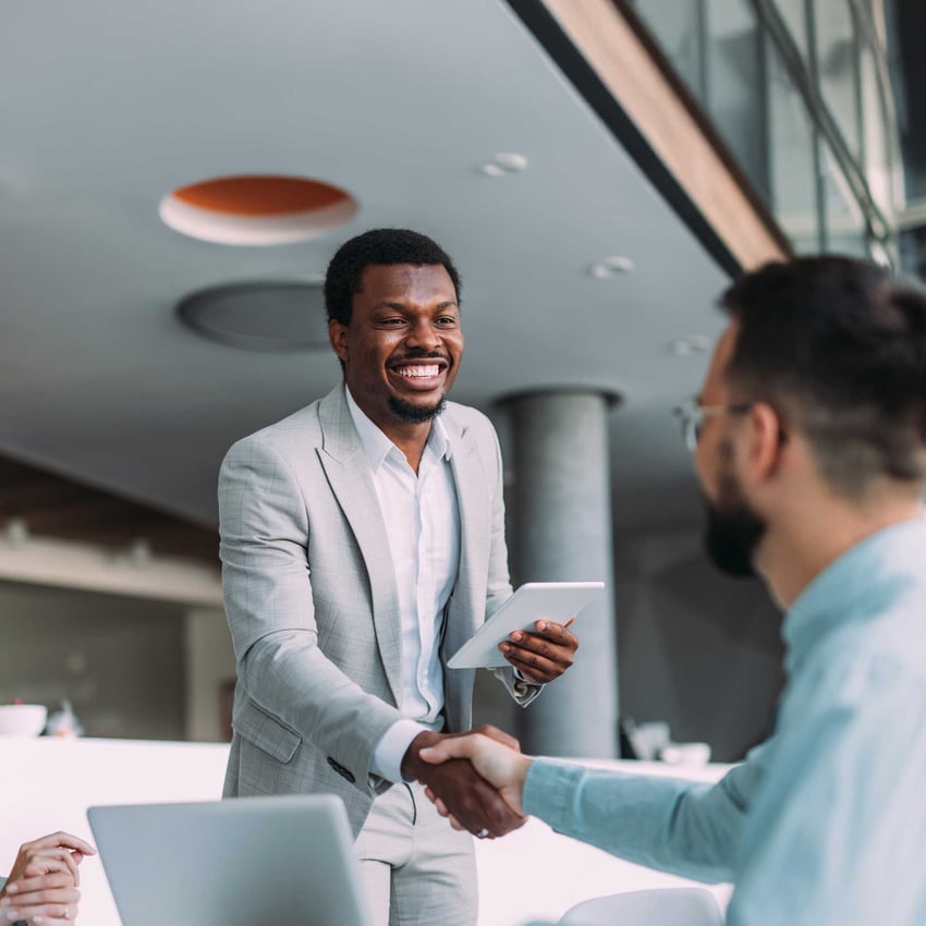 Online MBA graduate in a suit, in a meeting, discussing business ideas.