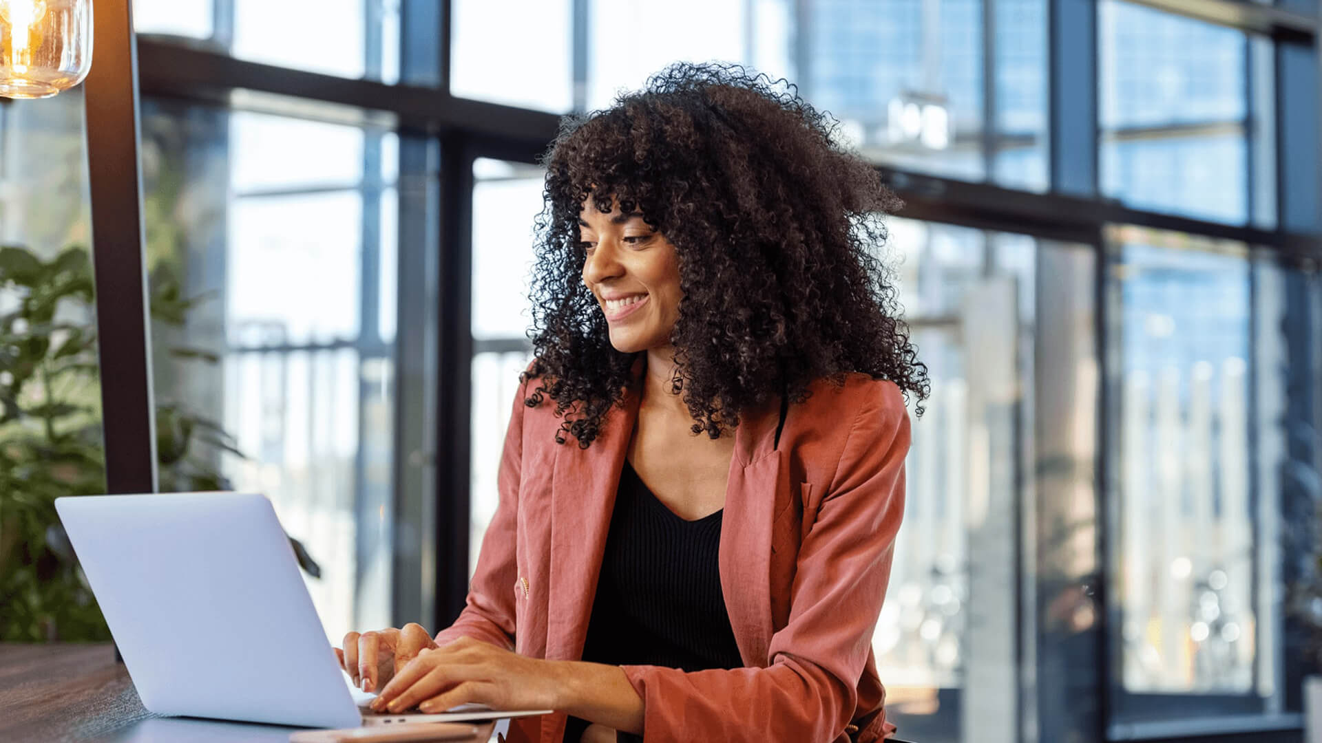 Young woman working on laptop at office cafe