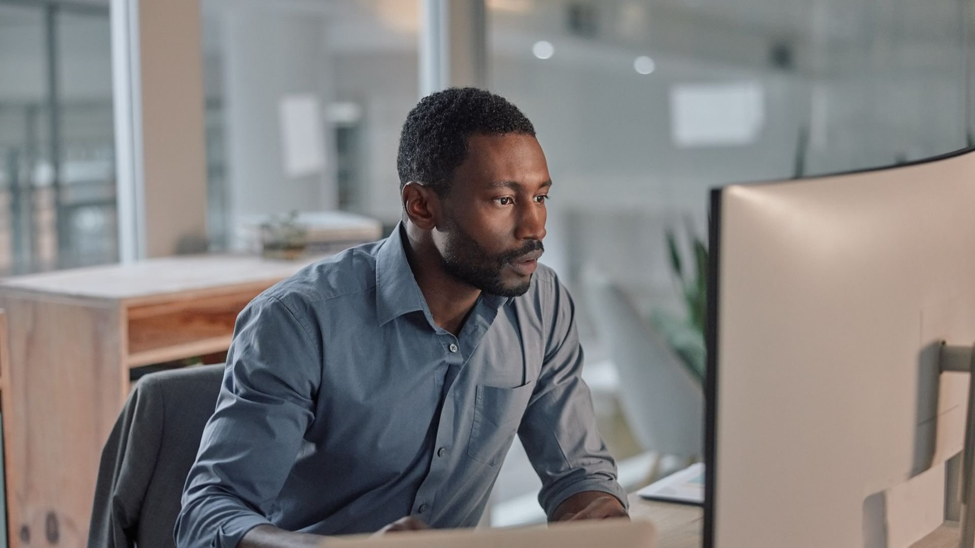 Man working on a monitor in an office environment