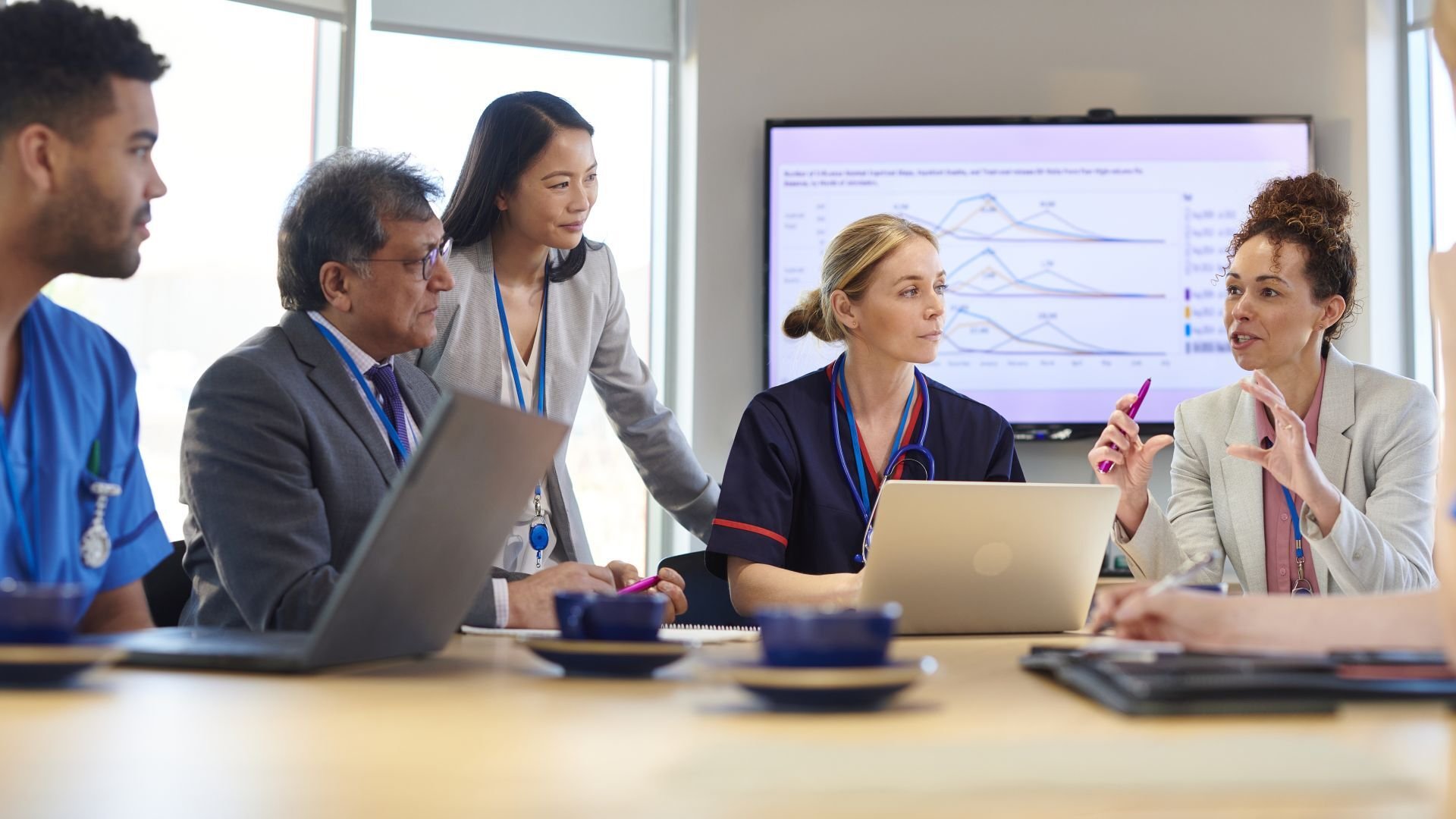 Woman in medical advisory role discusses something during a meeting