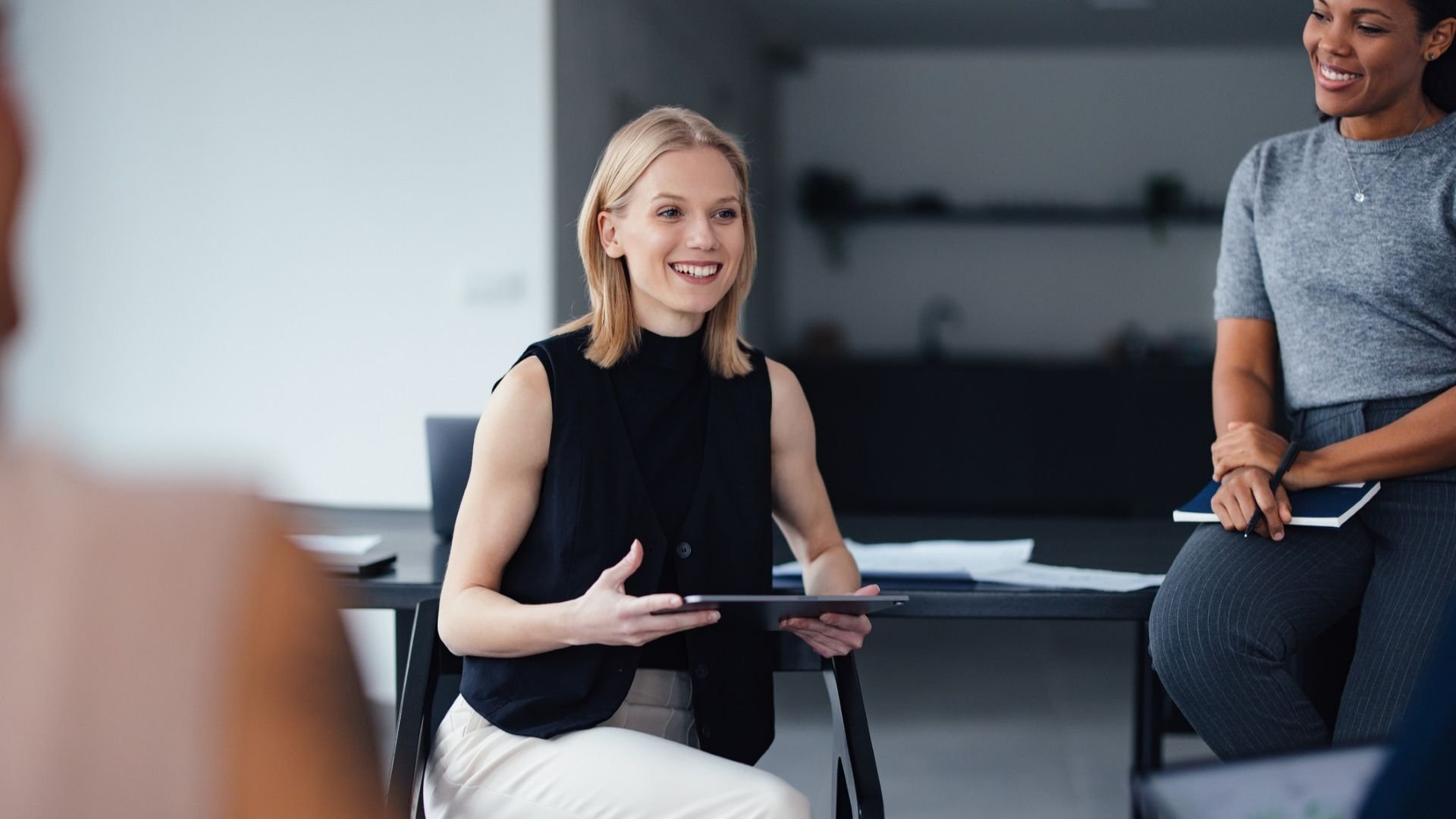 Woman talking and leading a meeting with coworkers