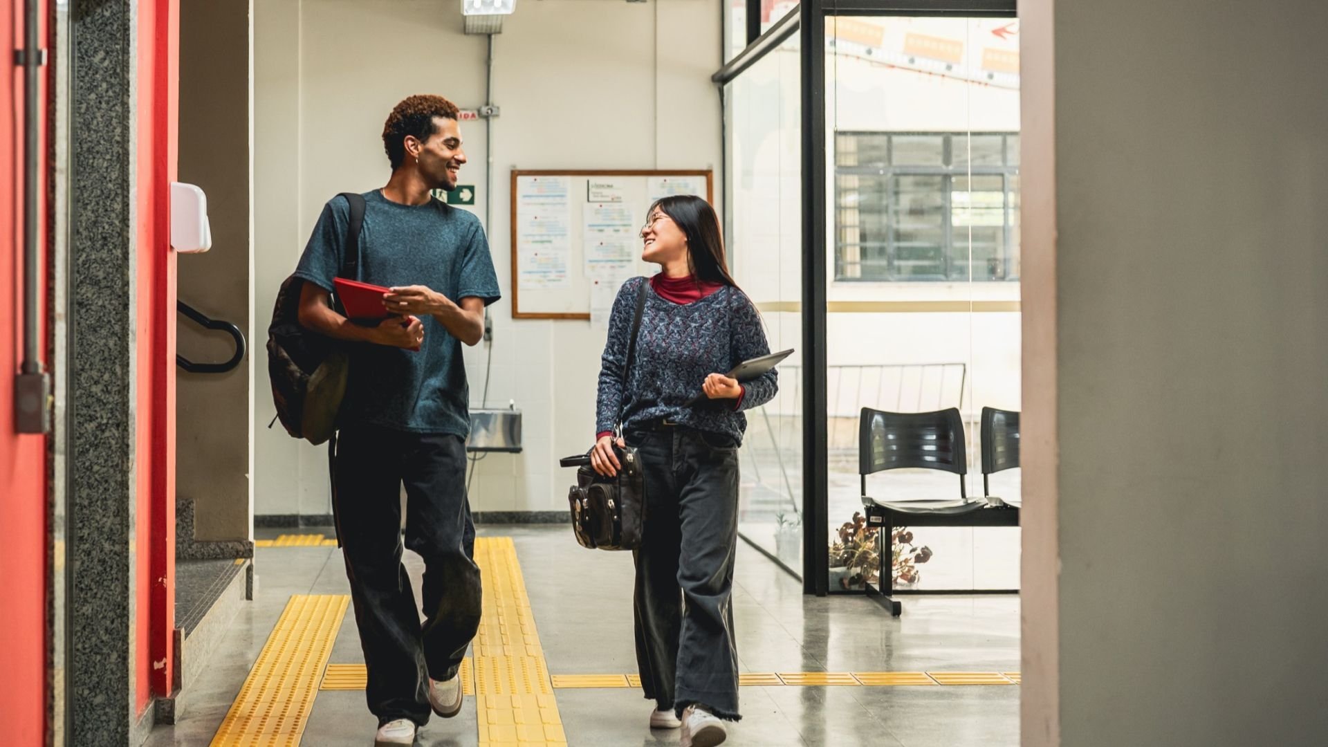 Two students walking together and laughing