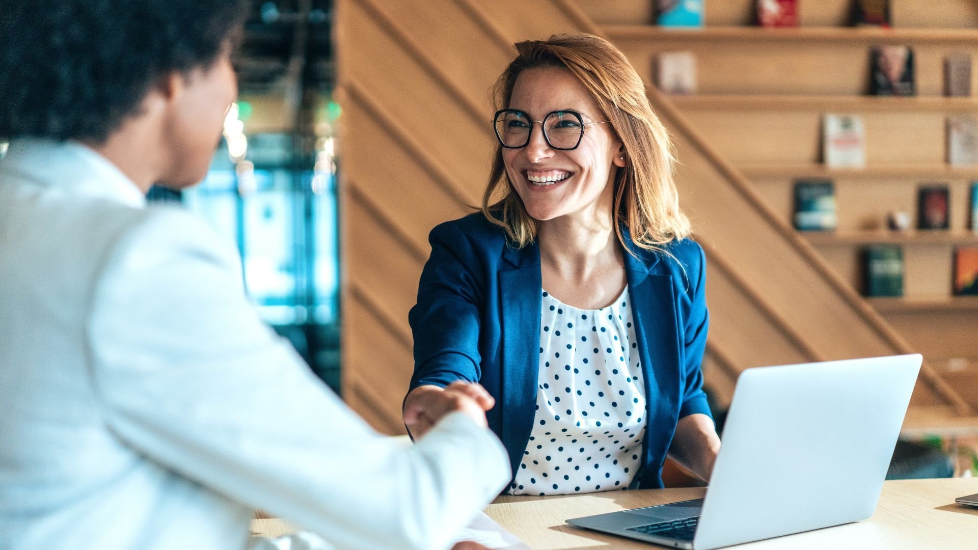 Woman shaking hands with someone during a meeting