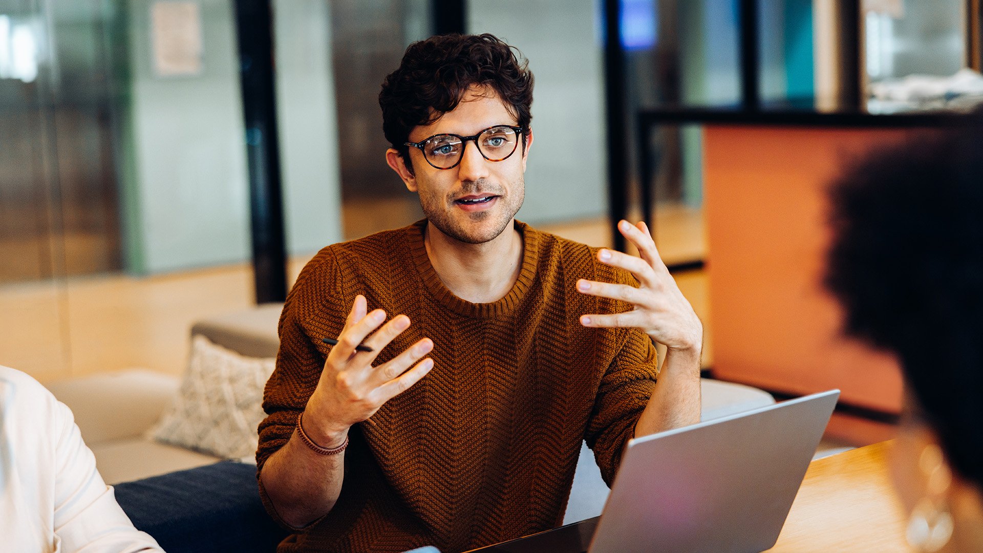Man discussing something with others in a work environment