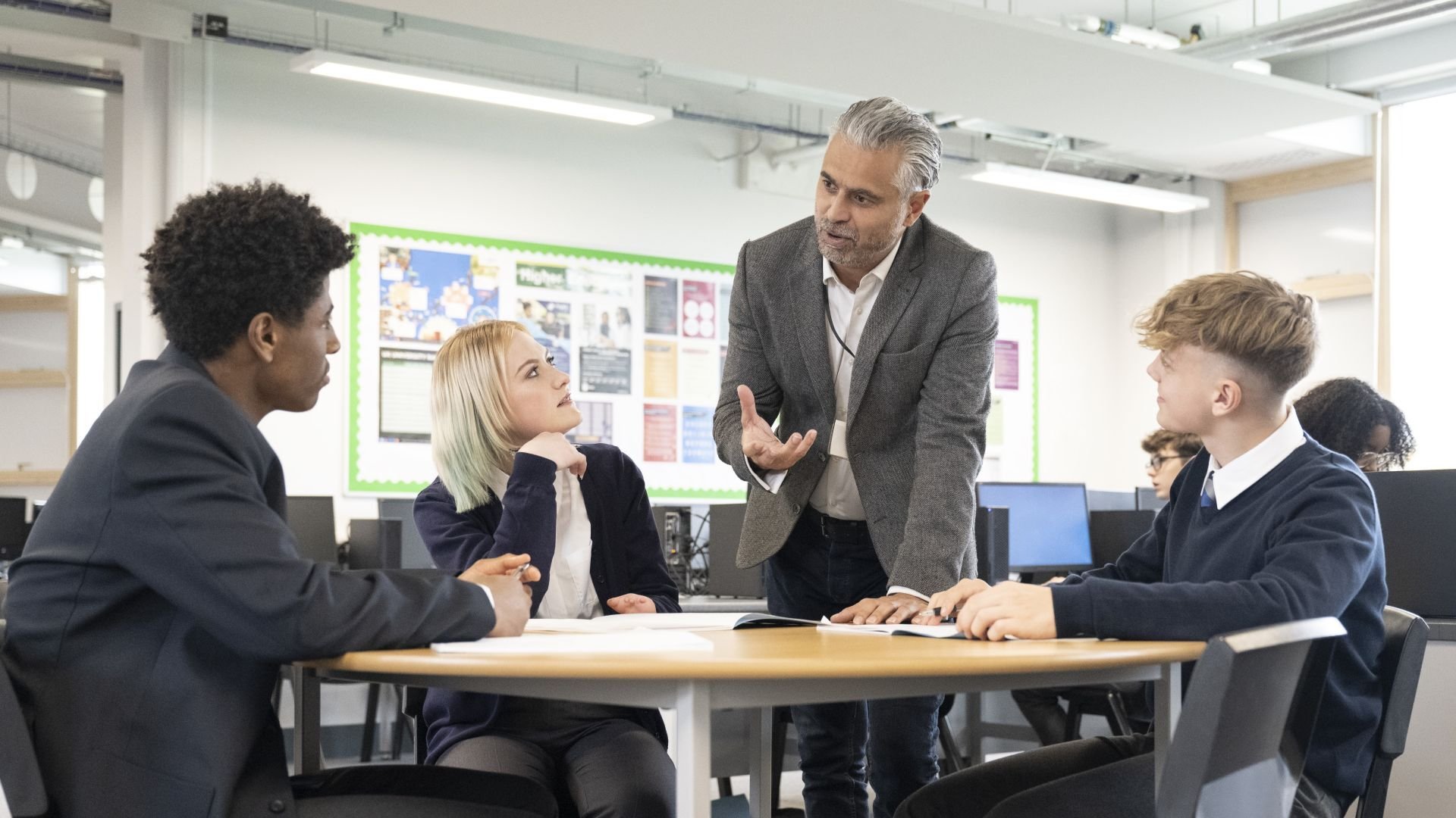 Man talking to a table of students