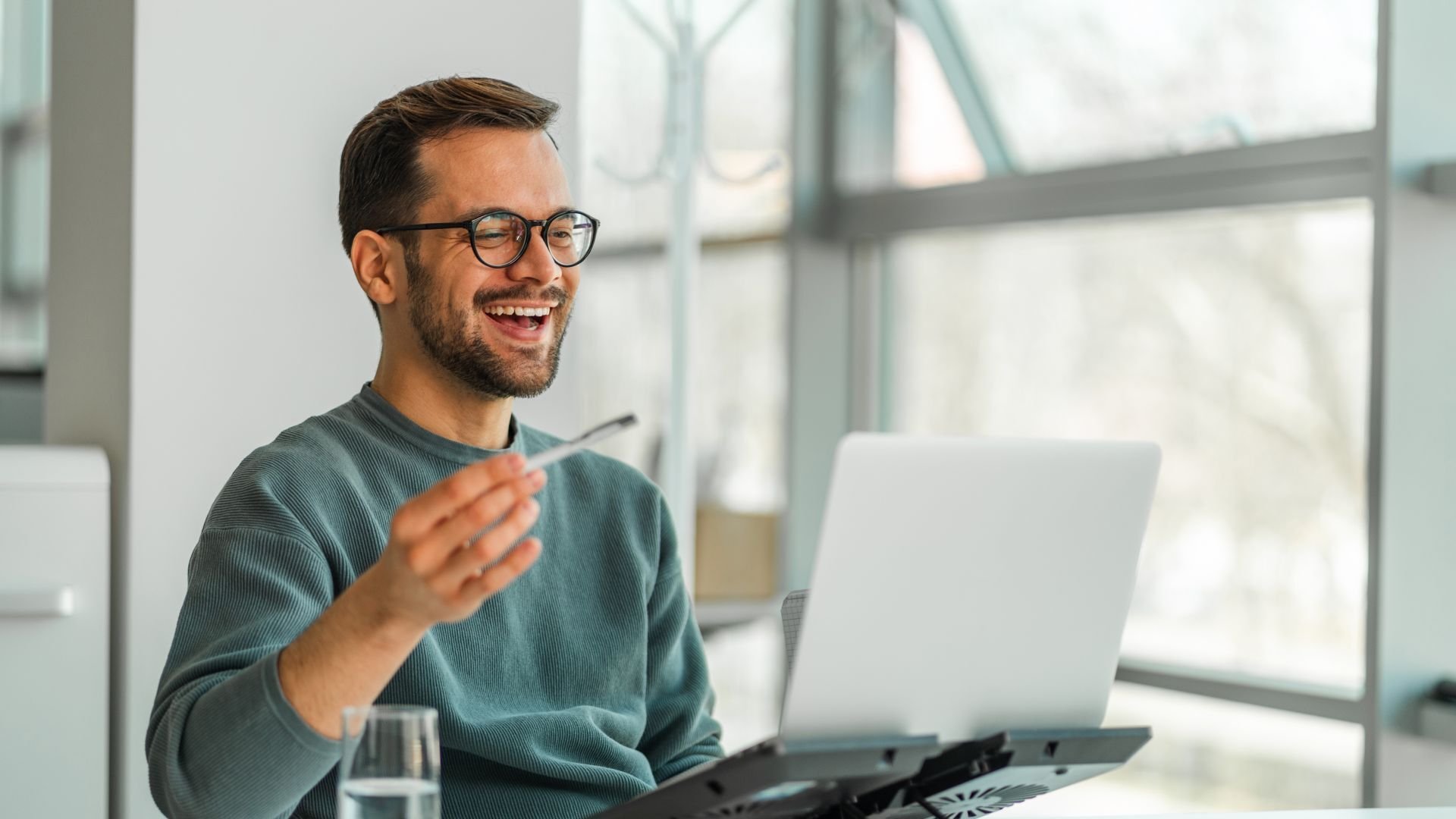 Man conversing with someone over laptop