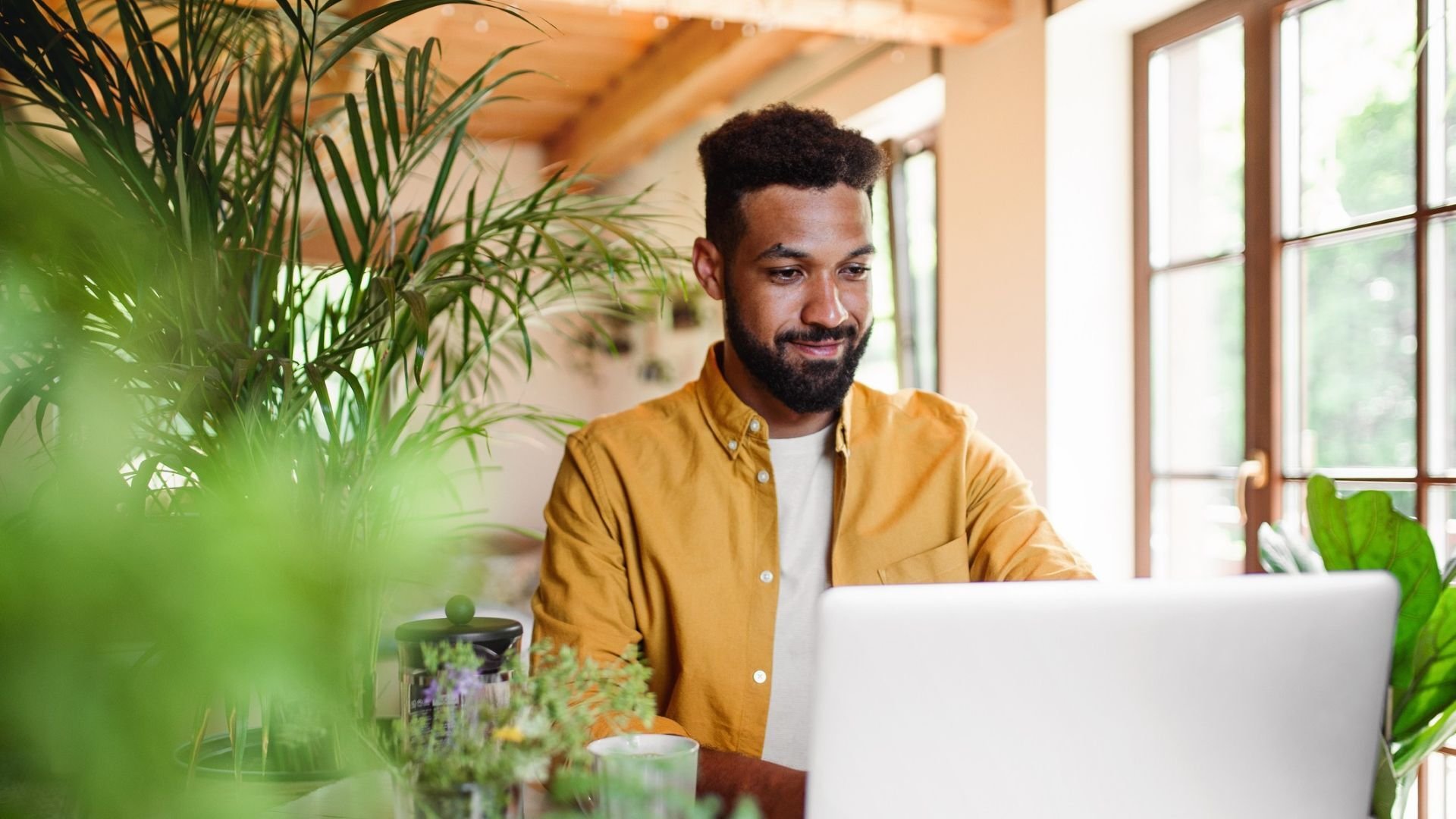 Man working on laptop in a home environment