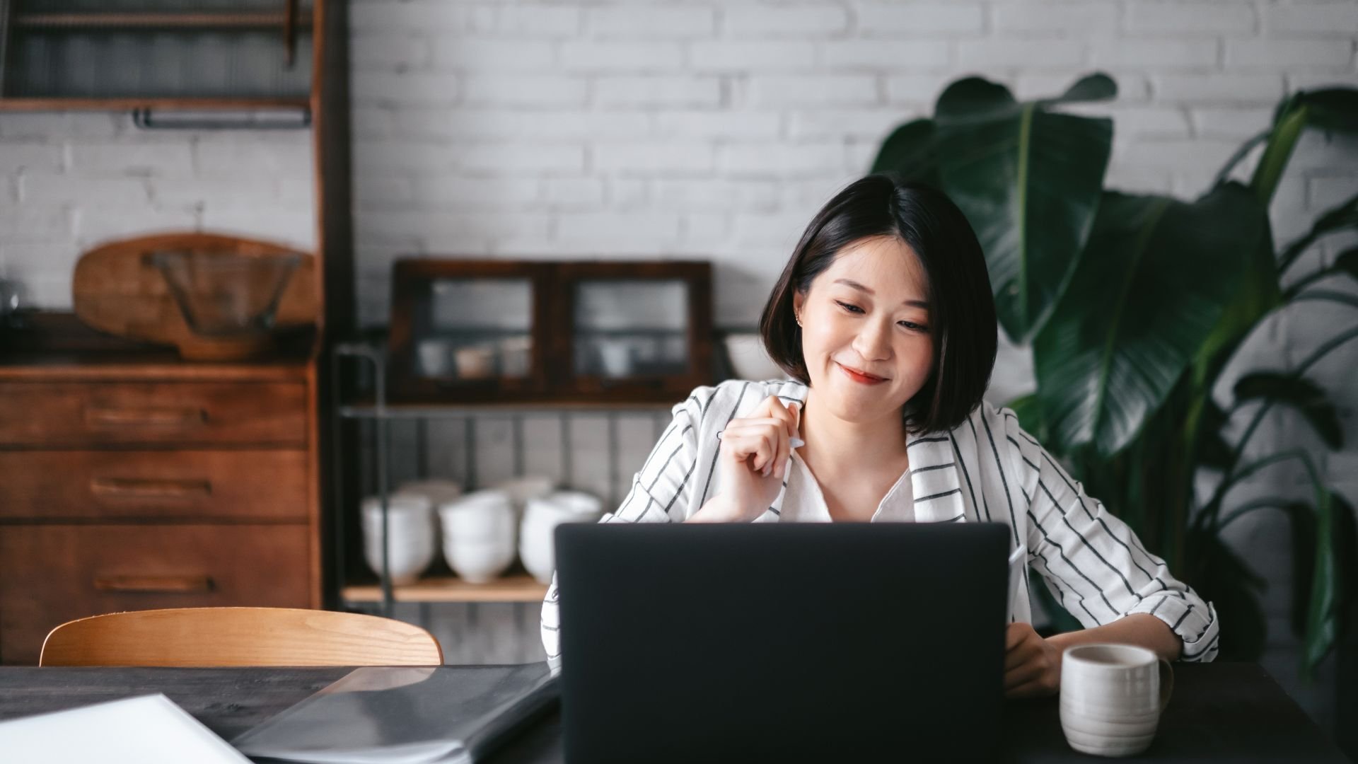 Woman working on her laptop in a home environment