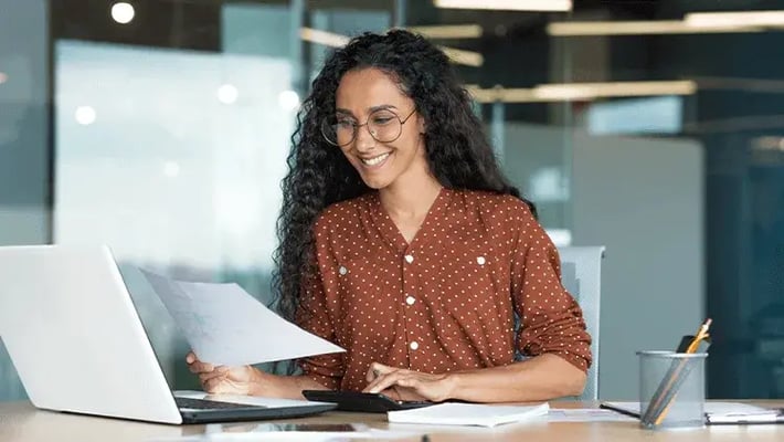 Woman in spotted orange shirt learns about the skills you need to develop human language AI apps.