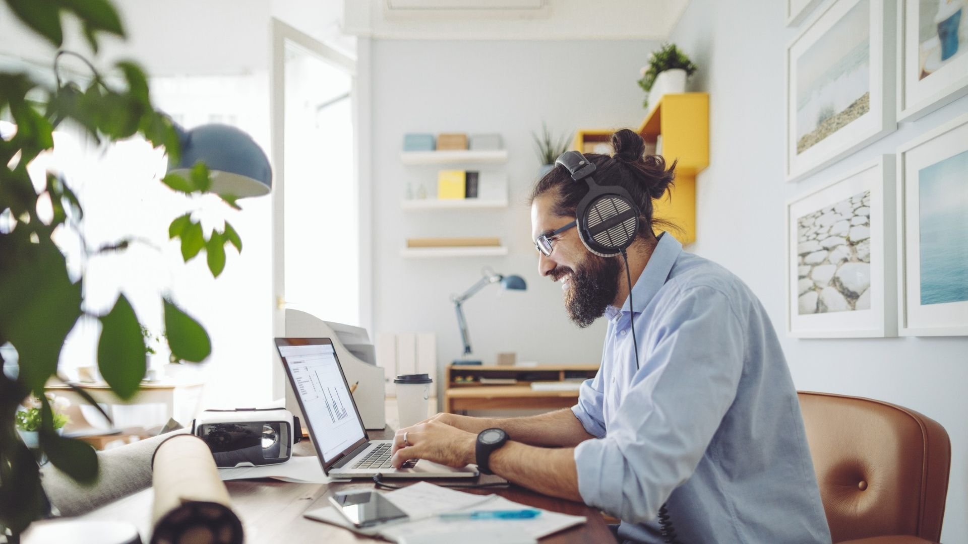 Man wearing headphones working on his laptop