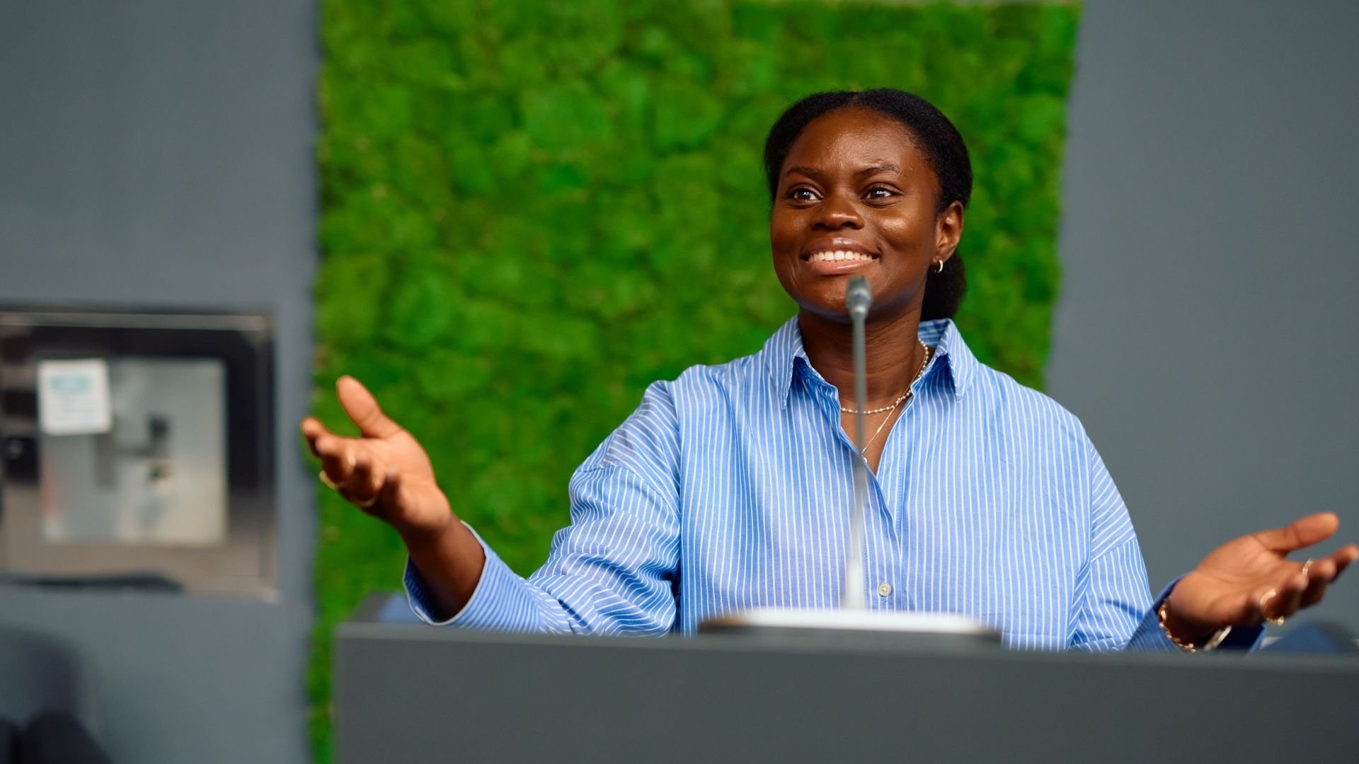 Woman giving a talk into a microphone