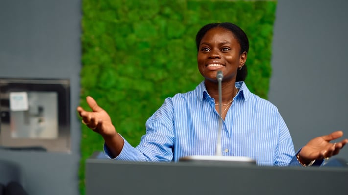 Woman giving a talk into a microphone