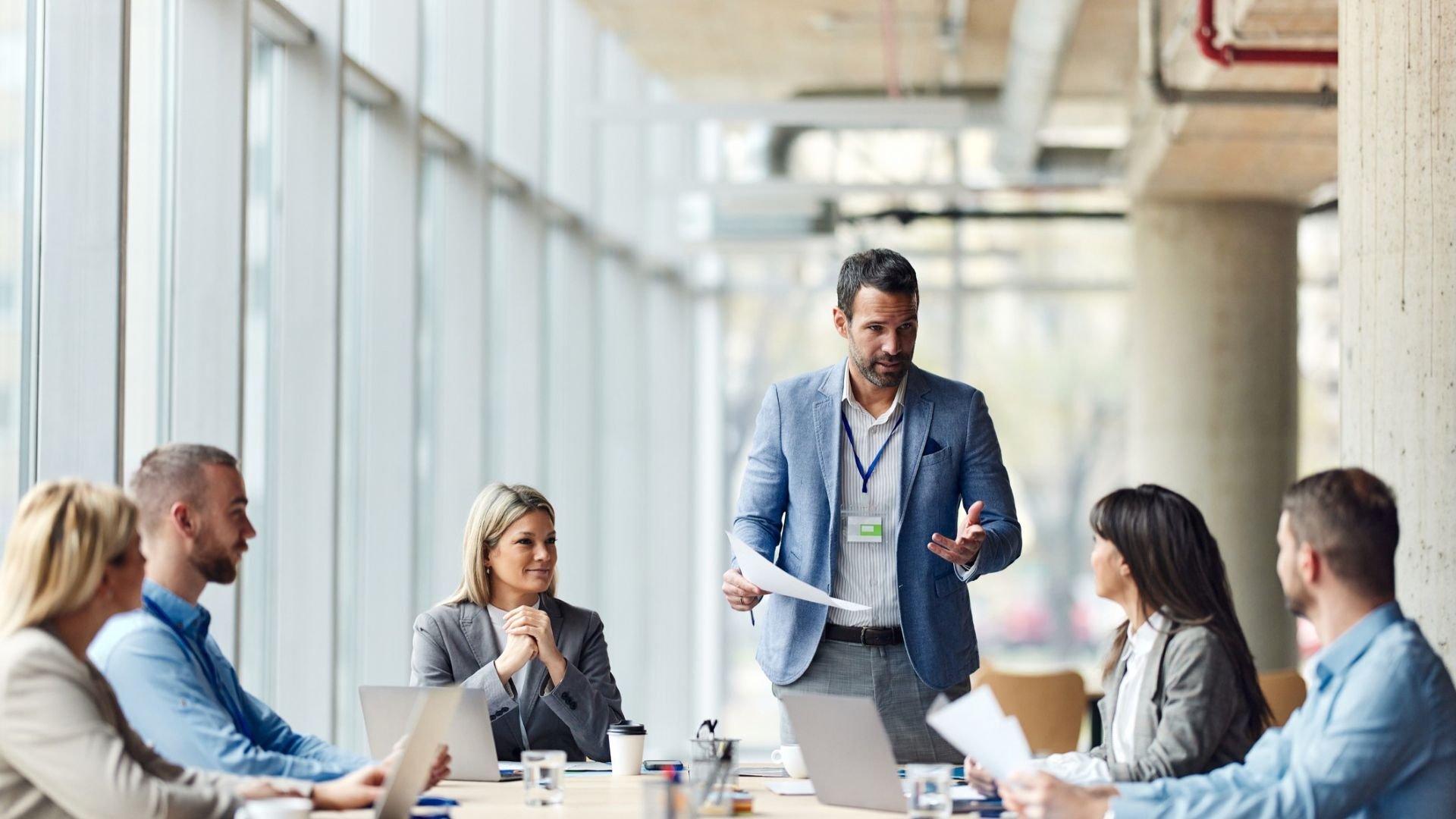 Man standing up and talking during a work meeting