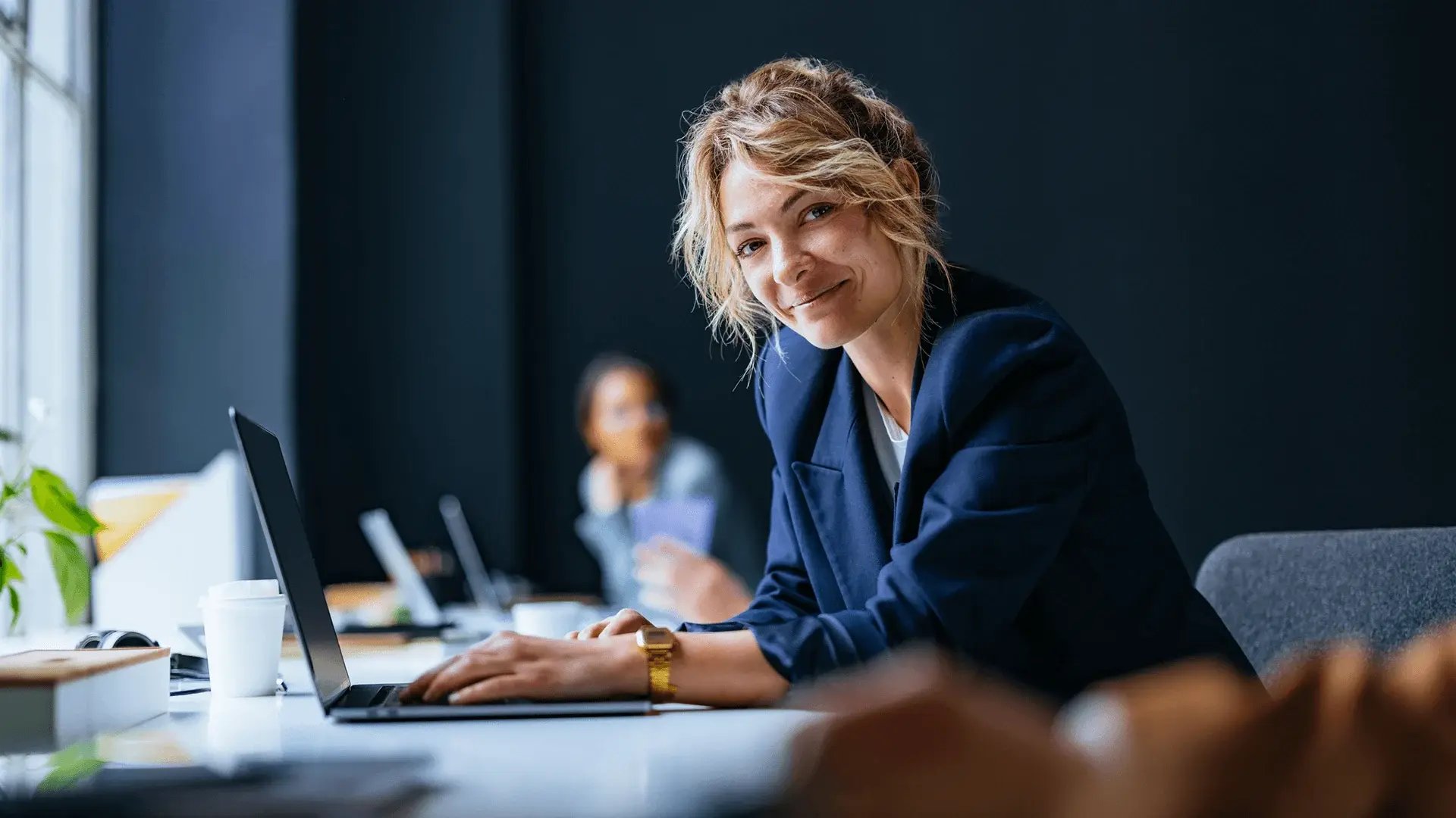 Professional woman in blue blazer searches for business and management courses for professional development.