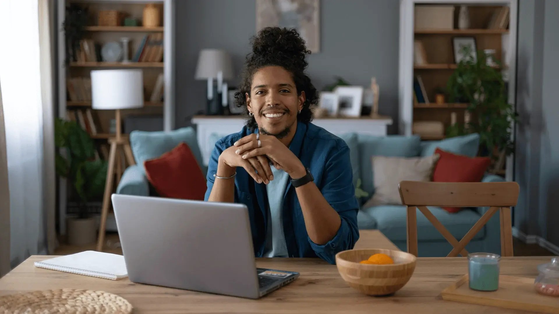 Student working on a laptop in a modern living space, showing supported online MBA study with Walbrook.