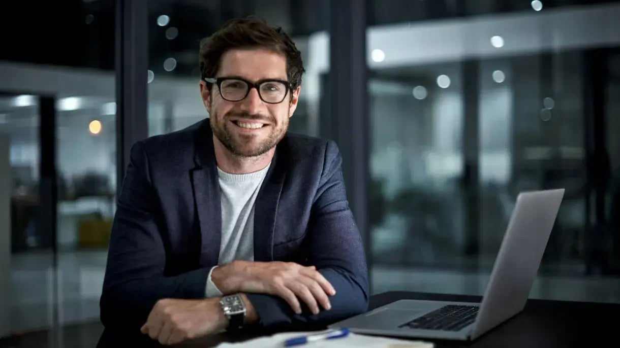 A man sat in a modern office, preparing an analytics report