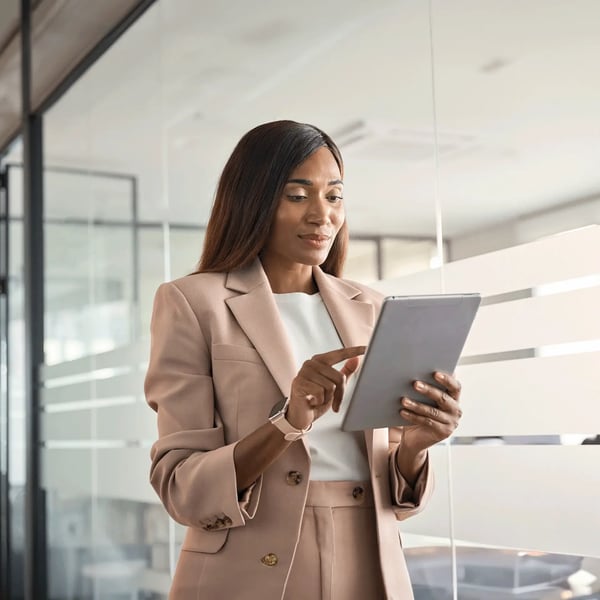 A young woman holding an iPad researching the available professional qualifications