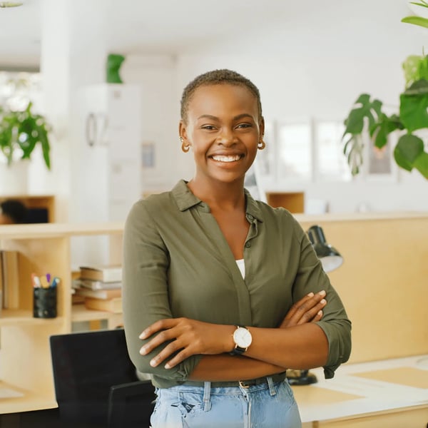 A young woman stood in a modern office, happy about her student finance application