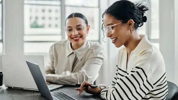 Focused MBA Innovation graduate presents project updates during a creative brainstorming session.