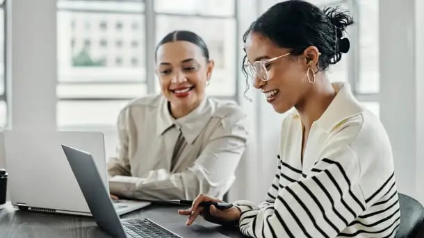 Focused MBA Innovation graduate presents project updates during a creative brainstorming session.