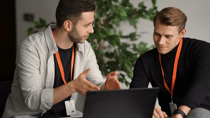Male Walbrook students at laptop studying accredited course.