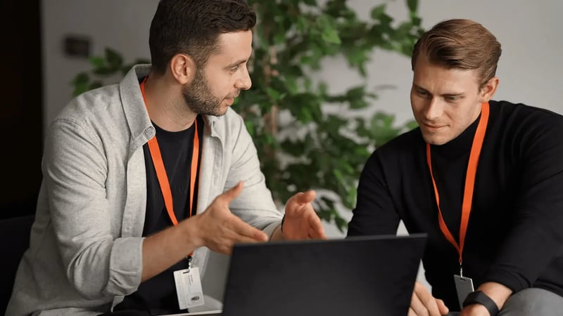 Male Walbrook students at laptop studying accredited course.